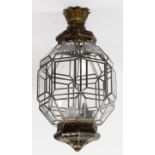 A 20th Century Moroccan gilt metal and glass hanging lantern
The faceted ovoid shape glass shade,