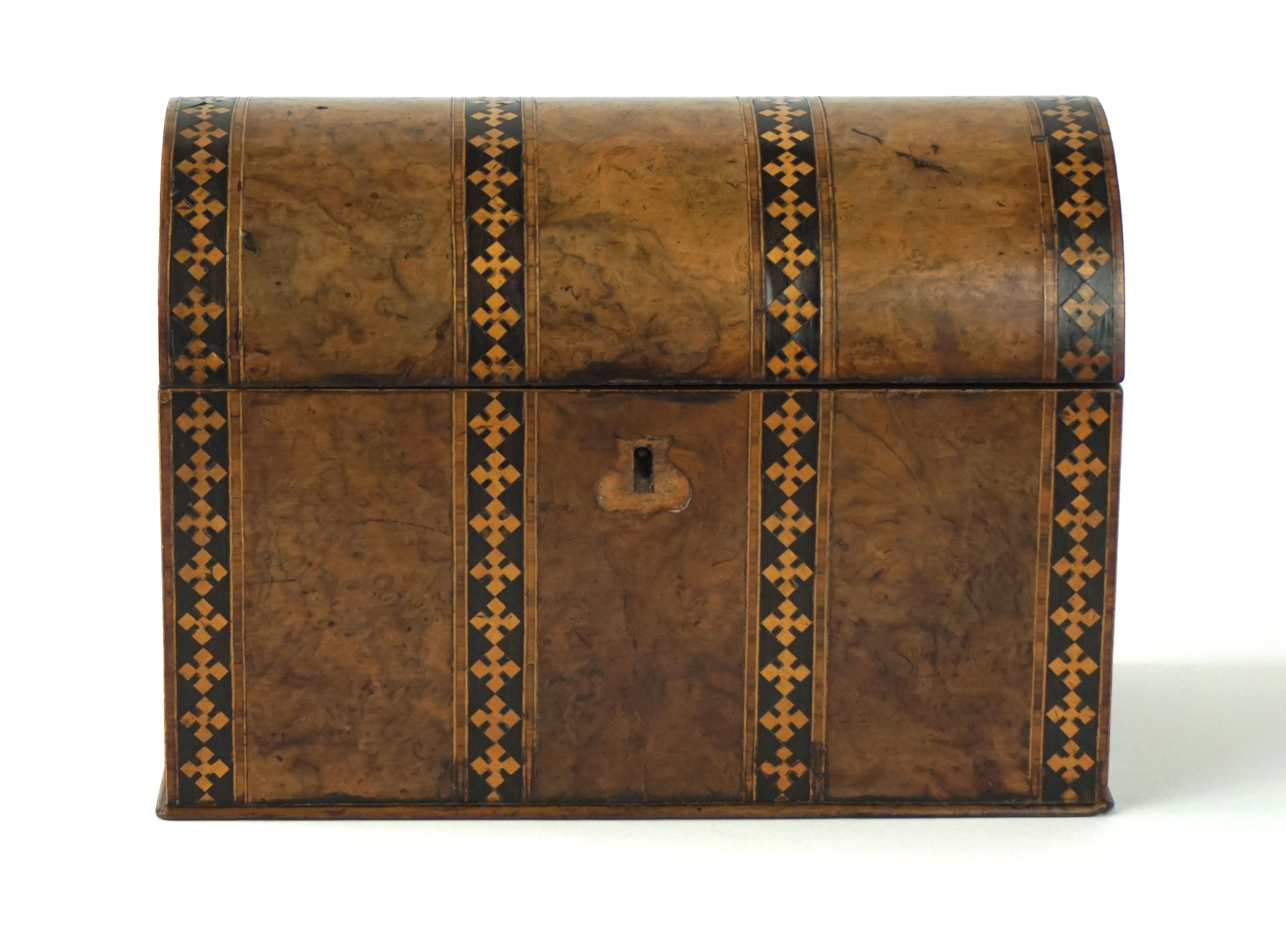 A 19th Century walnut veneered and inlaid tea caddy
Of casket form, the domed cover revealing two