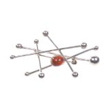 Neiels Erik From: A circa 1960's Danish silver and amber satellite brooch
Of abstract form set with