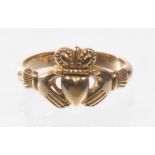 A stamped 18ct gold Claddagh ring
Of typical form of hands holding a heart surmounted with a crown,
