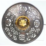 A large silver plaid brooch
The central round mixed Cairngorm within a pierced work border of