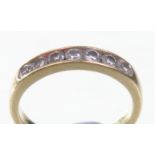 An 18ct gold diamond set half eternity ring
The seven round brilliant cut diamonds channel set to