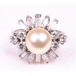 A platinum cultured pearl and diamond set cocktail ring
The central cultured pearl of approximately