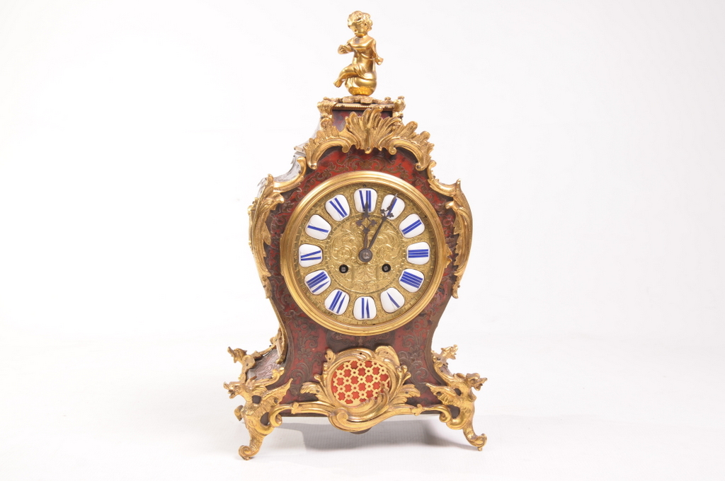A French Louis XV style boulle mantel clock
With a 14cm brass dial with blue and white enamel