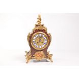 A French Louis XV style boulle mantel clock
With a 14cm brass dial with blue and white enamel