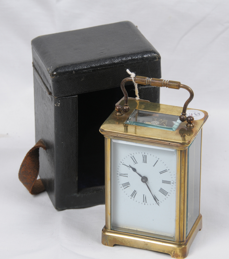 A French brass carriage timepiece and travelling case
With a 5.5cm white dial with Roman numerals