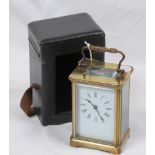 A French brass carriage timepiece and travelling case
With a 5.5cm white dial with Roman numerals
