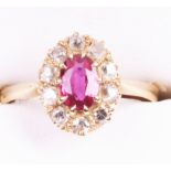 An 18ct gold synthetic ruby and diamond cluster ring
The oval mixed cut synthetic ruby claw set