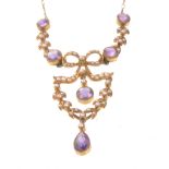 An early 20th century amethyst and seed pearl set pendant necklace
The pendant section set with