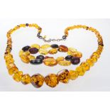 A circa 1920/30's faceted amber necklace 
Comprising graduated honey yellow and cherry red beads to