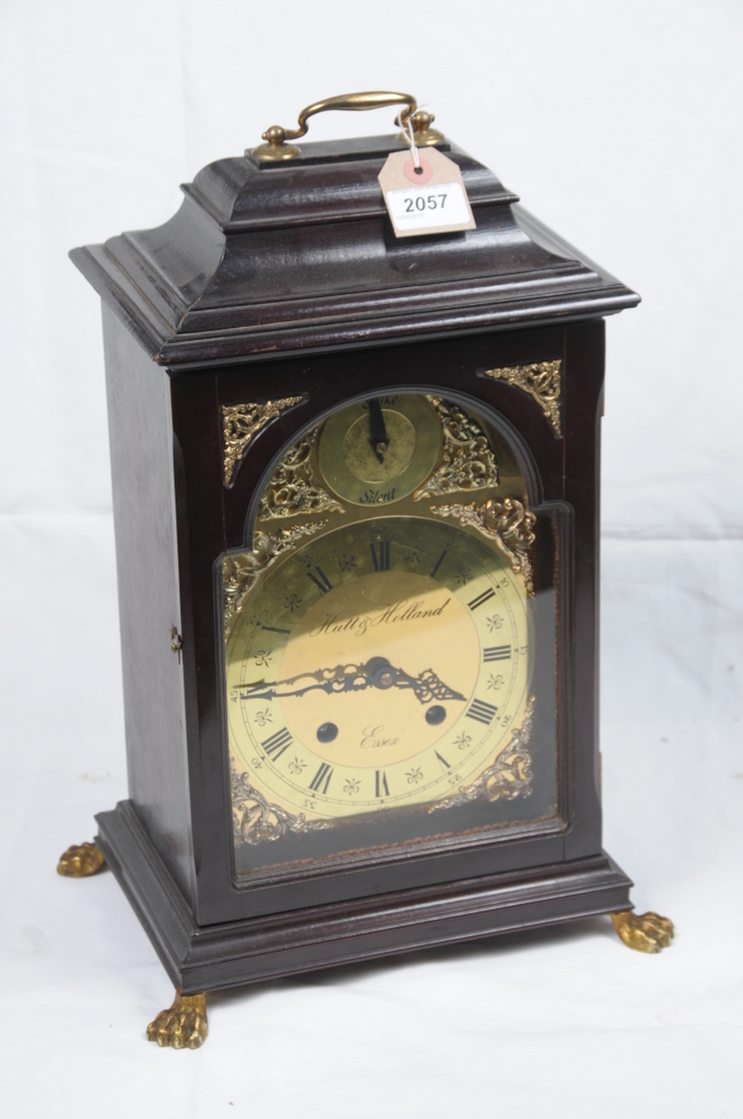 A stained wood bracket clock 20th Century reproduction
With a 17cm brass dial signed Hutt of