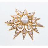 A late 19th Century star form pearl set brooch/pendant
Of open work form abundantly set with split