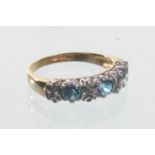 A 9ct gold blue topaz and diamond set dress ring
The three round cut blue topaz inter spaced with