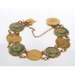 A jade plaque and coin set bracelet
Set with alternate round jade plaques and mounted gold coins to