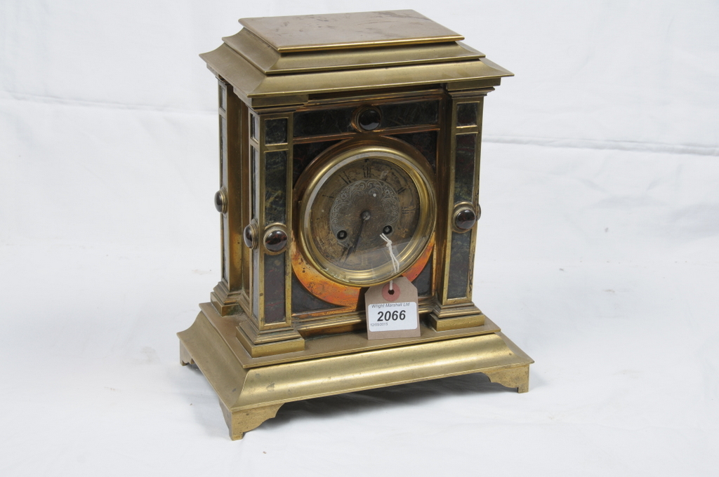 A Victorian brass variegated marble and hardstone mantel clock
With a 9cm dial with Roman numerals,