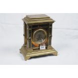 A Victorian brass variegated marble and hardstone mantel clock
With a 9cm dial with Roman numerals,