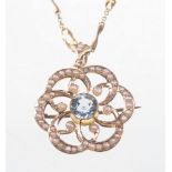 An early 20th Century 9ct gold paste and split pearl set pendant
The central pale blue paste stone