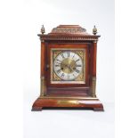 A simulated walnut cased mantle clock early 20th Century
With a 13cm silvered dial with Roman