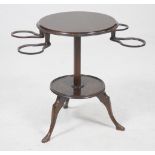 An early 20th Century oak wine table
With a 44cm diameter moulded top above four pendent spindles