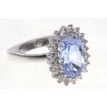 Mauboussin: an 18ct white gold sapphire and diamond set cluster ring
The oval mixed cut sapphire