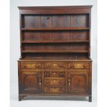 A late George III oak and inlaid high dresser
North Wales the boarded rack with an ovolo cornice