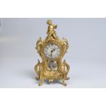 A gilt Spelter and porcelain mantle timepiece,