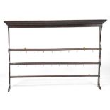 A late 18th early 19th Century oak open plate rack
With an ovolu cornice above a plain frieze and