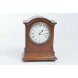 A late 19th early 20th Century oak mantle timepiece
With a 9cm bowfront dial signed JW Benson Ltd.