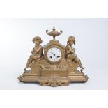 A 19th Century gilt spelter figural mantle clock
With a 8cm white enamel dial with Roman numerals,