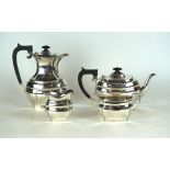 A hallmarked silver four piece tea service
Of square panelled form, raised on stepped base,