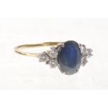 A sapphire and diamond set dress ring
The central oval mixed cut sapphire of approx 9x6mm four claw