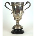 A Victorian hallmarked silver two handled trophy cup
The tapering vase shape body embossed with