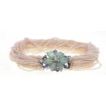 A mid 20th Century emerald sapphire diamond and seed pearls set bracelet
The naturalistic floral