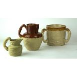 A collection of three Staffordshire stoneware jugs
The first modelled with Lurcher modelled handle