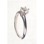 Tiffany & Co: A diamond single stone ring 
The round brilliant cut diamond six claw set to plain