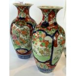 A pair of Japanese Imari vases depicting scenes of birds in flight and floral decoration.