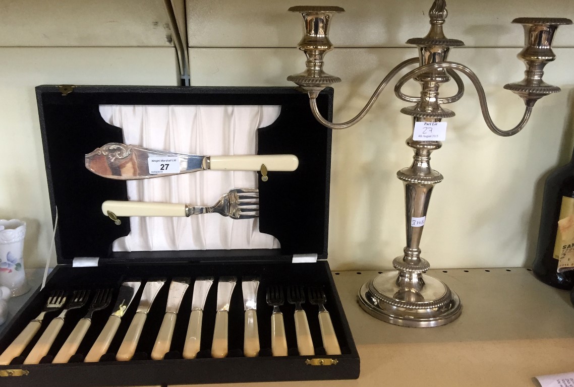 A modern silver-plated candelabra together with a silver-plated cased fish knives and fork set.