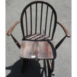 A 20th Century stained oak spindle back rocking chair.