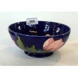 A Walter Moorcroft 'Magnolia@ pattern bowl, decorated upon a cobalt blue ground.