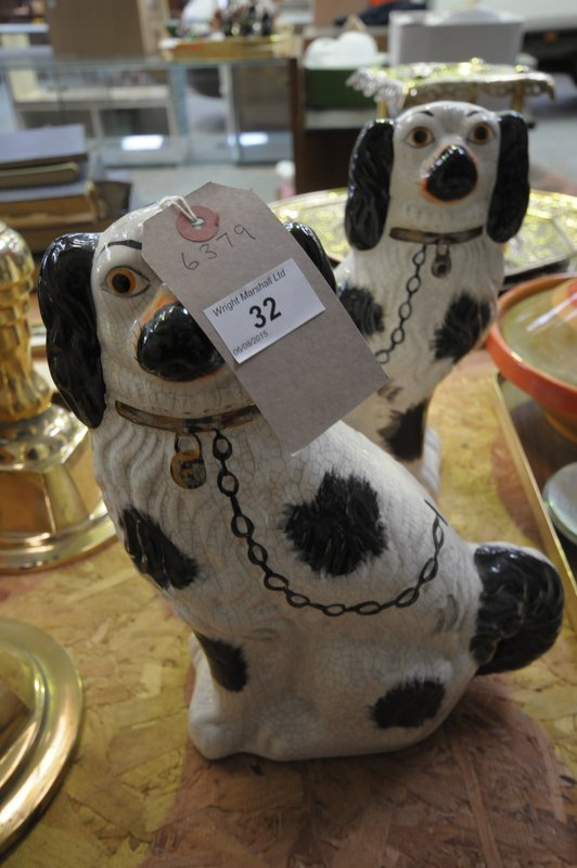 A Pair of black and white Victorian style Staffordshire dogs.