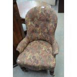 A Victorian walnut and upholstered button back nursing chair.