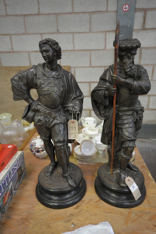 A Bronze patinated terracotta figure of a warrior on an integral circular plinth and a companion .