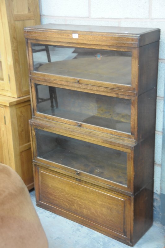 An Oak Globe Wernick " Classic" 4 tier stacking bookcase with 3 glazed sliding doors above a