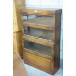 An Oak Globe Wernick " Classic" 4 tier stacking bookcase with 3 glazed sliding doors above a