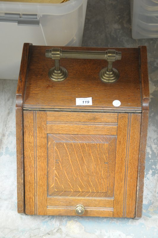 A Victorian oak coal scuttle with a reeded brass handle and brass hinges.