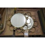 A Pair of gilt metal circular mirrors within hooped rope twist and flowerhead frames.