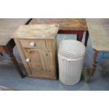 A Victorian pine side cabinet with a single frieze drawer and cupboard door and a Lloyd Loom style