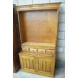A Stained hardwood bookcase with 3 enclosed shelves above 4 small drawers and 2 cupboard doors,