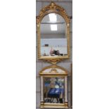 An Ornate gilt framed arched wall mirror with a shell crest and a second similar mirror with