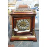 A simulated walnut cased mantle clock early 20th Century
With a 13cm silvered dial with Roman